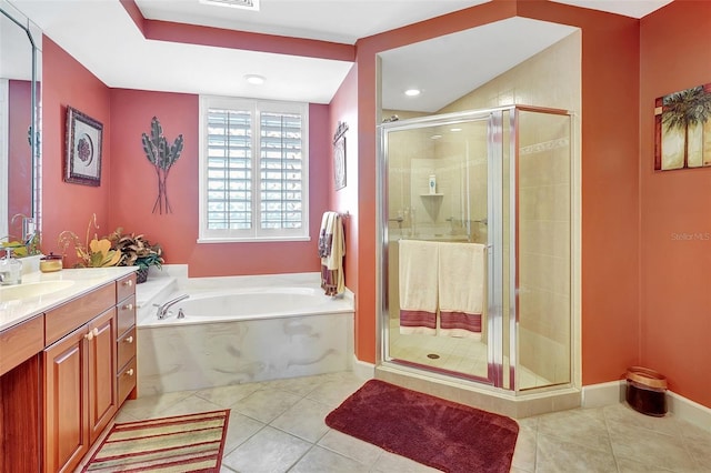 bathroom with tile patterned floors, vanity, and separate shower and tub