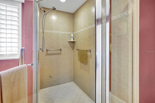 bathroom with a shower with door