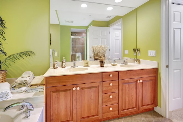 bathroom featuring tile patterned flooring, vanity, and an enclosed shower