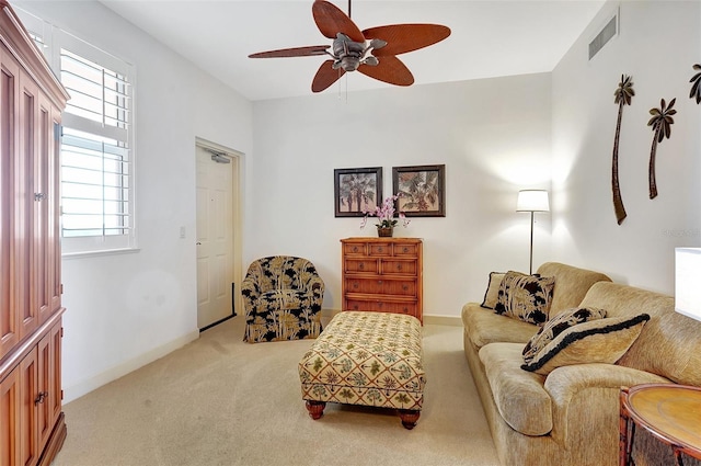 sitting room with ceiling fan, plenty of natural light, and carpet floors