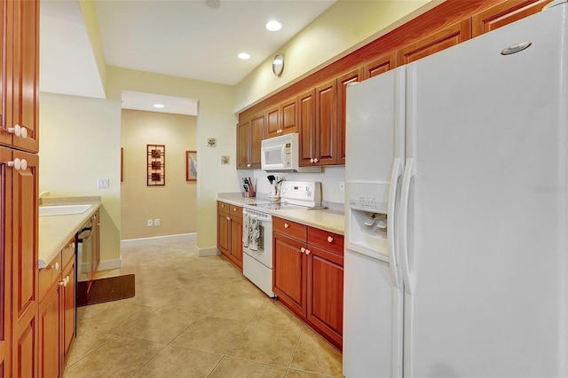 kitchen with light tile patterned flooring, white appliances, and sink