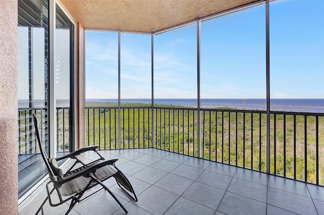 unfurnished sunroom with a water view