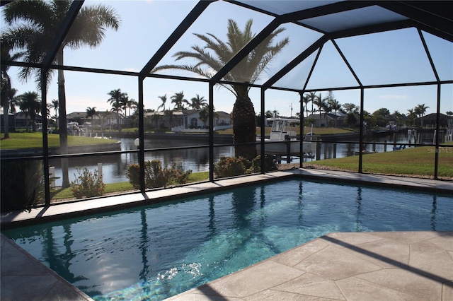 view of pool featuring glass enclosure and a water view