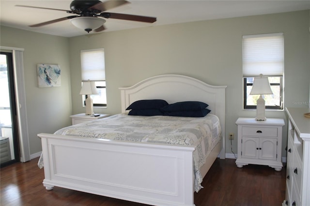 bedroom with multiple windows, ceiling fan, and dark wood-type flooring