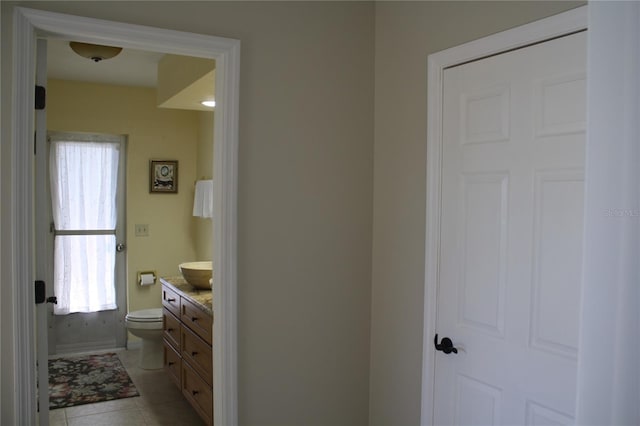 bathroom with tile patterned floors, vanity, and toilet