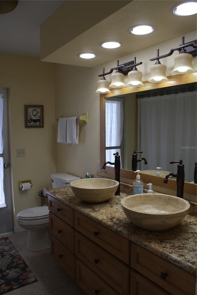 bathroom with tile patterned flooring, vanity, toilet, and a shower with shower curtain