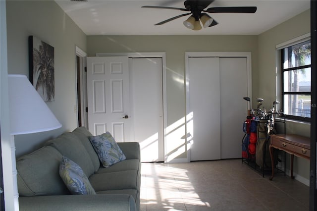 tiled living room with ceiling fan