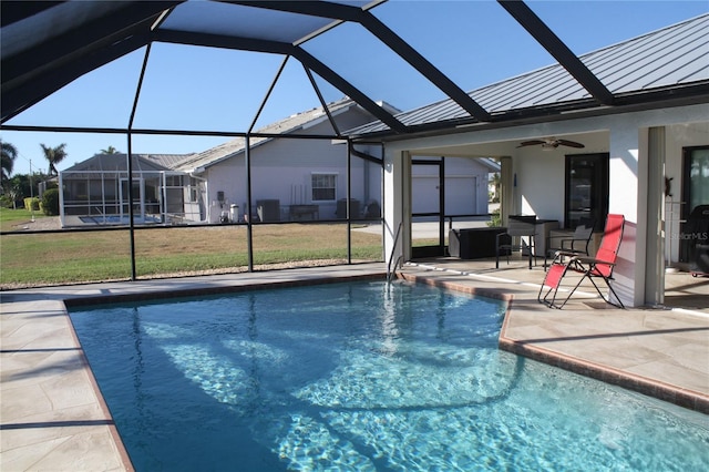 view of pool with ceiling fan, a patio, and glass enclosure