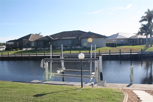 dock area with a water view and a yard