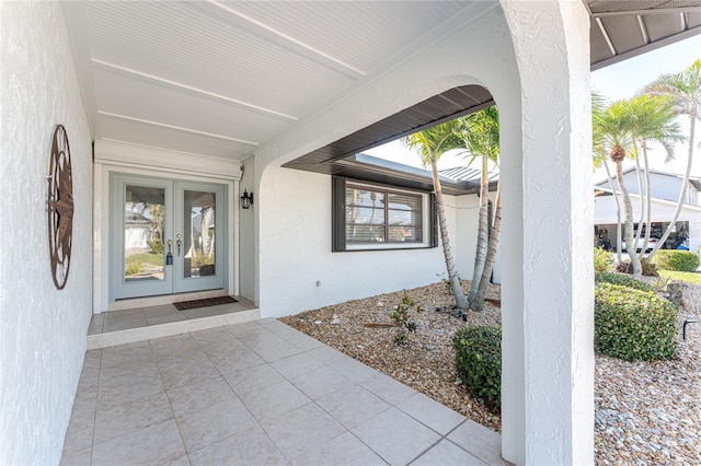 view of exterior entry featuring french doors