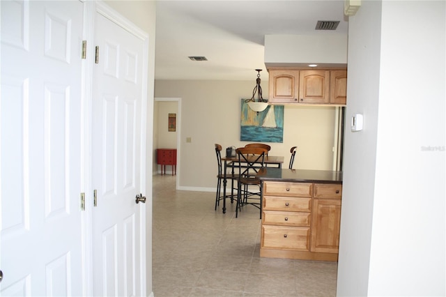 kitchen featuring light tile patterned floors and decorative light fixtures