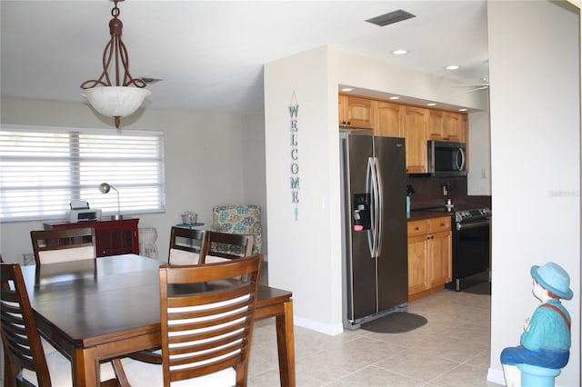 kitchen featuring decorative backsplash, appliances with stainless steel finishes, ceiling fan, pendant lighting, and light tile patterned flooring