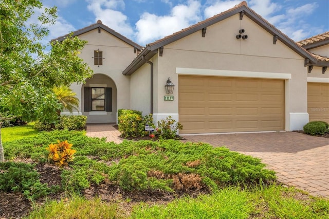 mediterranean / spanish house featuring a garage