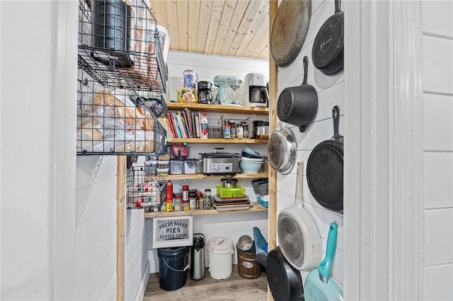 laundry room with hardwood / wood-style floors and wooden ceiling