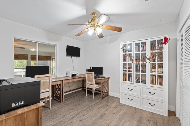 office space featuring light wood-type flooring and ceiling fan