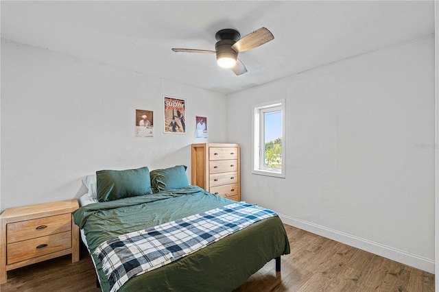 bedroom with ceiling fan and dark hardwood / wood-style flooring