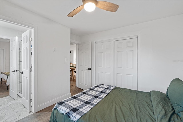 bedroom featuring hardwood / wood-style floors, ceiling fan, and a closet