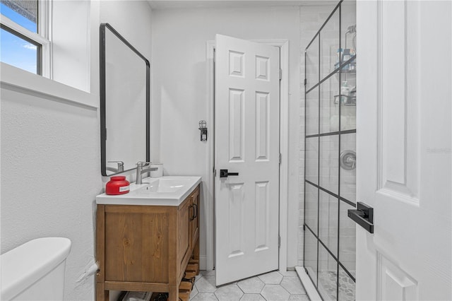 bathroom featuring toilet, vanity, and tile patterned floors