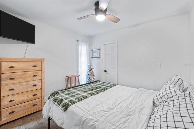 bedroom with ceiling fan and dark hardwood / wood-style flooring