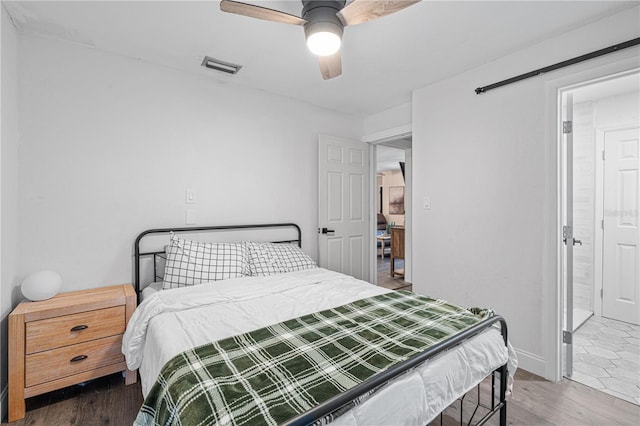 bedroom with ceiling fan and dark wood-type flooring