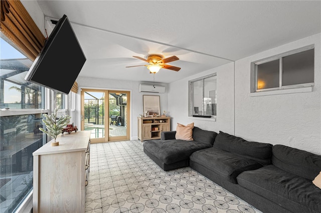 living room featuring ceiling fan and an AC wall unit