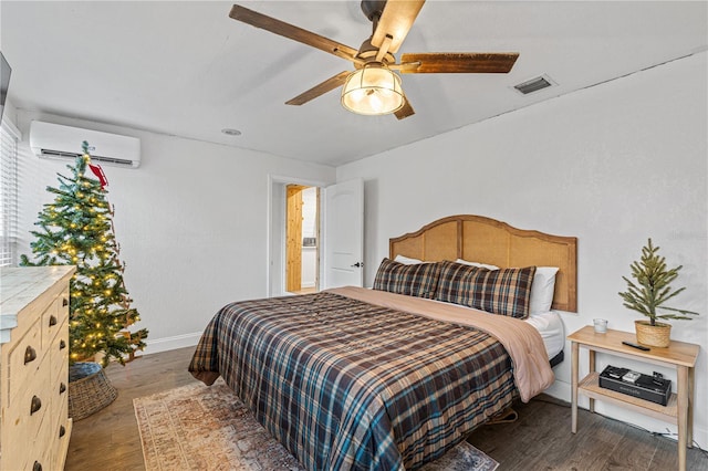 bedroom with a wall mounted air conditioner, ceiling fan, and dark hardwood / wood-style floors