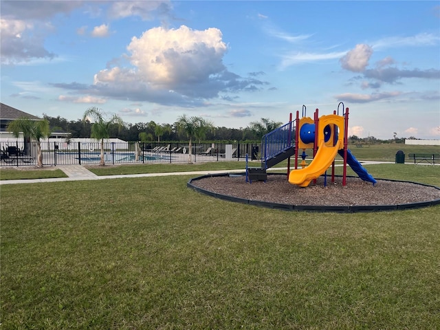 1984 Golden Beak Dr, Eagle Lake, FL 33839 - community play area featuring a community pool, fence, and a lawn