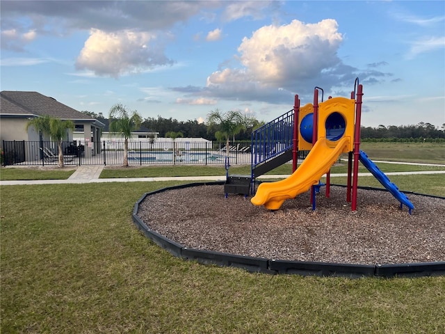 1984 Golden Beak Dr, Eagle Lake, FL 33839 - community play area with a yard, fence, and a community pool