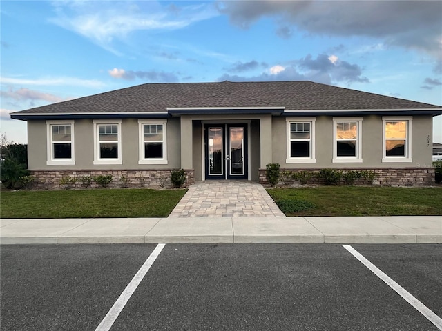 1984 Golden Beak Dr, Eagle Lake, FL 33839 - single story home with a front lawn, french doors, and stucco siding