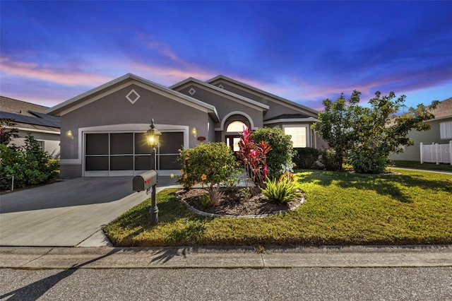 view of front facade with a lawn and a garage