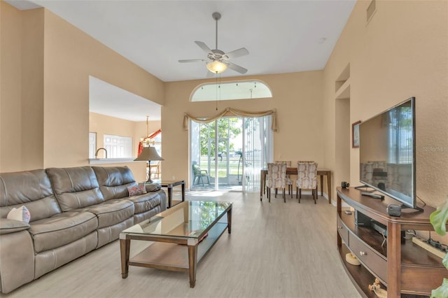 living room with ceiling fan and light hardwood / wood-style floors