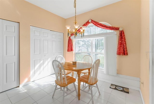 tiled dining area featuring a chandelier