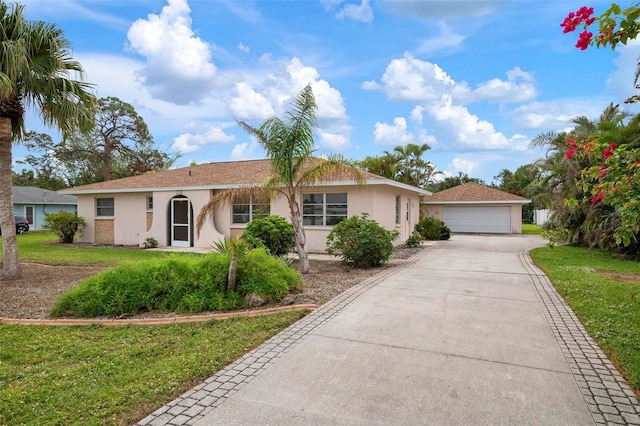 1713 Belvidere Rd, Englewood, FL 34223 - ranch-style house featuring stucco siding, a front lawn, an outbuilding, and a garage