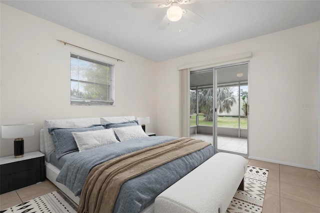 tiled bedroom with ceiling fan, access to outside, and multiple windows