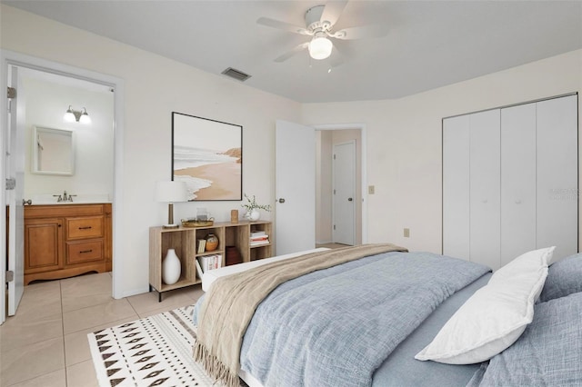 bedroom with ceiling fan, a closet, light tile patterned floors, and sink