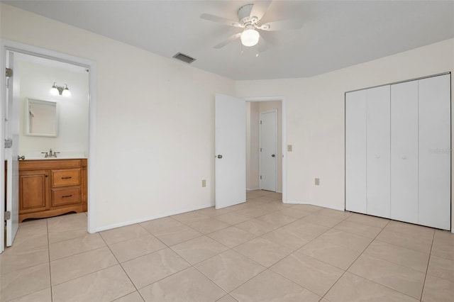 unfurnished bedroom featuring ceiling fan, sink, and light tile patterned floors