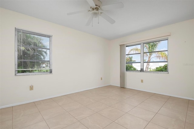 empty room featuring light tile patterned floors and ceiling fan