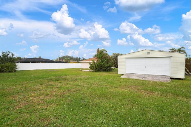 view of yard with a garage and an outdoor structure