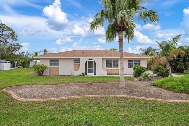 ranch-style home with a front lawn