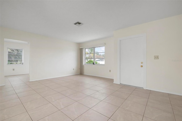 spare room with light tile patterned floors