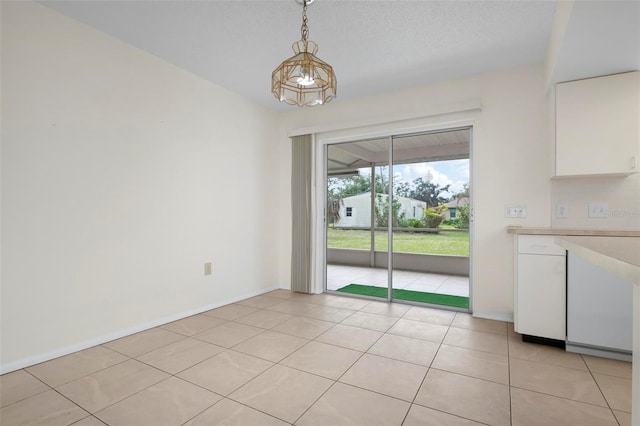 unfurnished dining area featuring light tile patterned floors