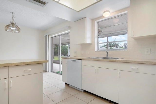 kitchen featuring white cabinets, sink, pendant lighting, dishwasher, and light tile patterned flooring