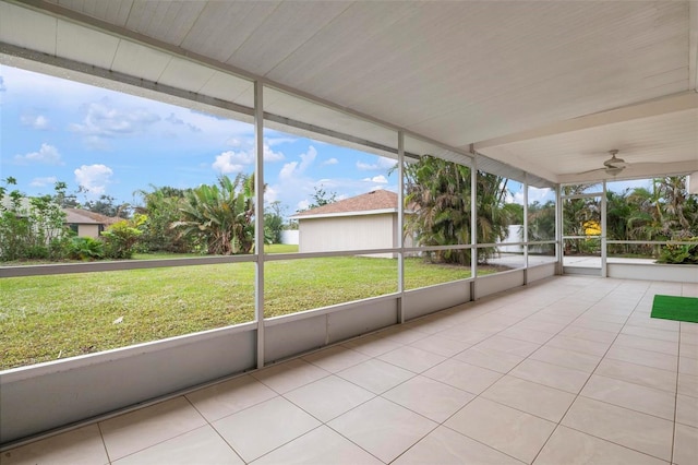 unfurnished sunroom with ceiling fan and a healthy amount of sunlight