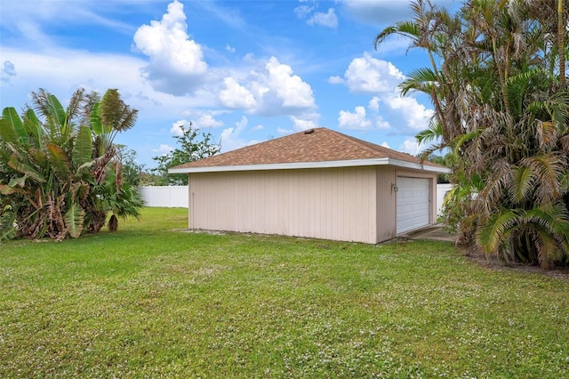 view of side of property with a lawn and a garage