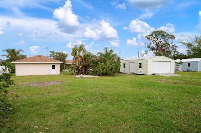 view of yard featuring an outbuilding and a garage