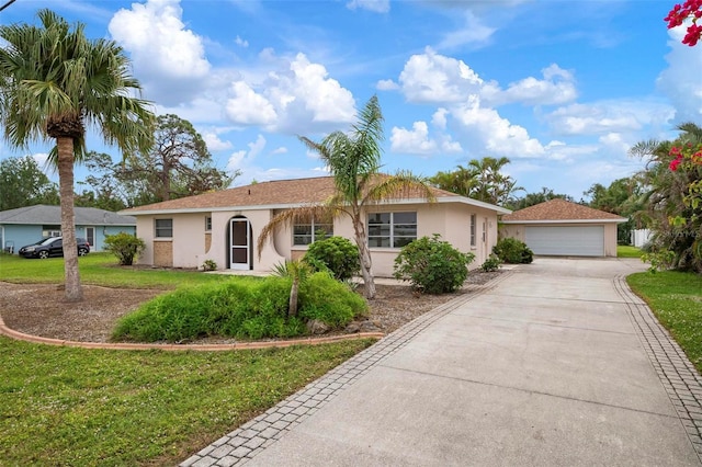 single story home with a front yard and a garage