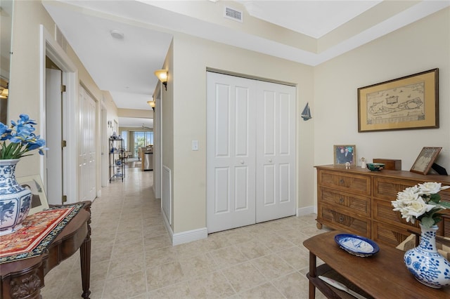 hall with light tile patterned floors