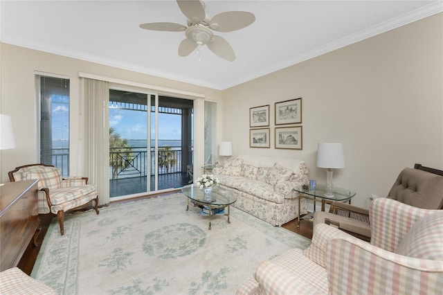 living room with ceiling fan and ornamental molding