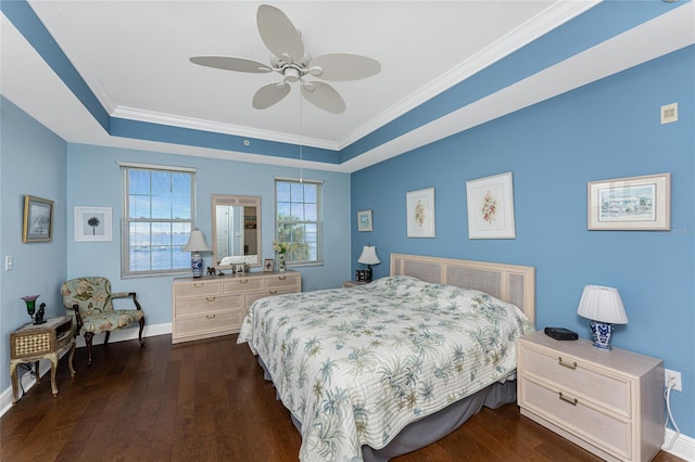 bedroom with dark hardwood / wood-style floors, a raised ceiling, ceiling fan, and ornamental molding