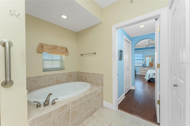 bathroom featuring tile patterned floors, ceiling fan, and tiled bath